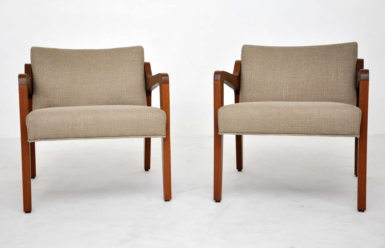 Mid Century lounge chairs. Fully restored walnut frames with great lines. Newly upholstered in woven mushroom color fabric.