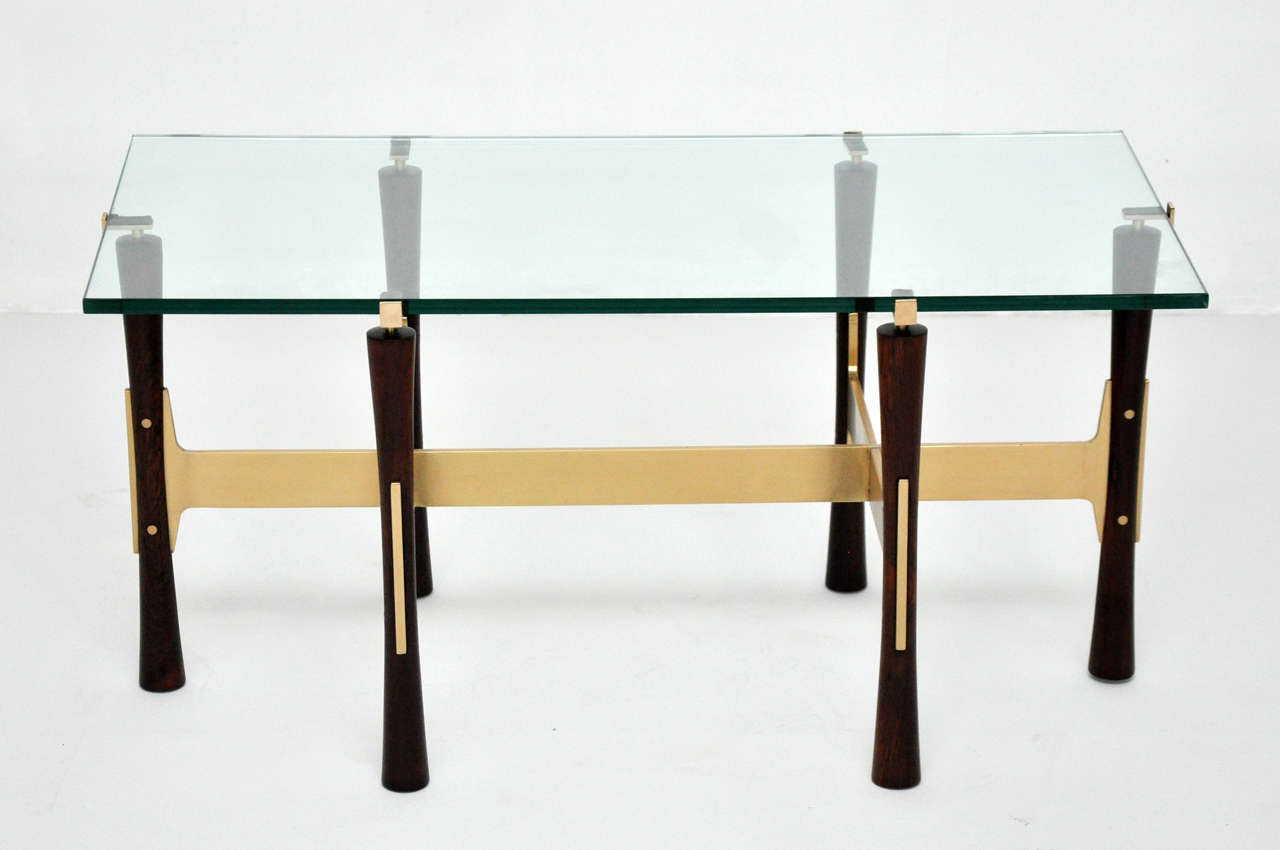Beautiful glass top coffee table.  Solid rosewood and brass base.  Table fully restored.  New glass.