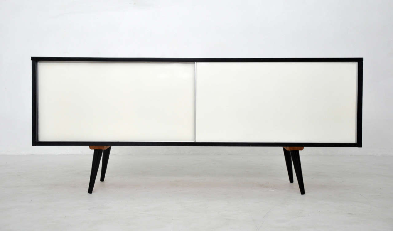 Ebony credenza by Paul McCobb.  Doors are reversible.  White one side, black other side.