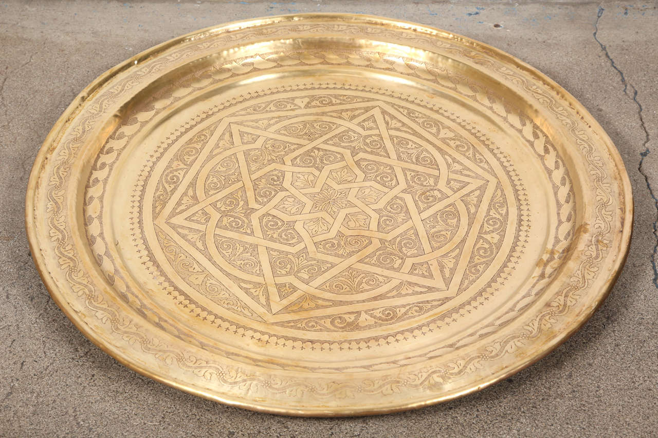 Stunning antique huge Moroccan heavy solid polished brass charger platter all hand tooled in exquisite foliate and geometrical designs. Could be used hanging on the wall, but also  great as occasional table as well on a small base, or just use it as