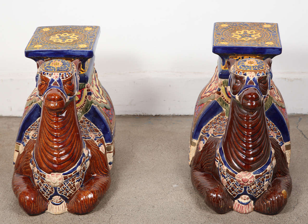 Pair of highly decorative Moroccan camel glazed ceramic garden seats.
1950's poly-chrome glazed ceramic garden seats,USA , 1950's. Beautiful bright colors and crisp details, these stools could be use for plant stand, side tables or also to make a
