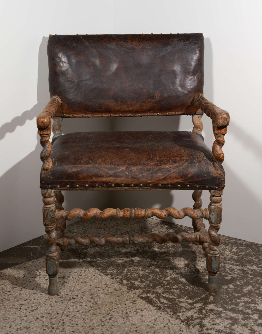 Late 17th c.- early 18th c. Baroque chair with barley twist carving and antique leather seat and back. Traces of original blue paint.