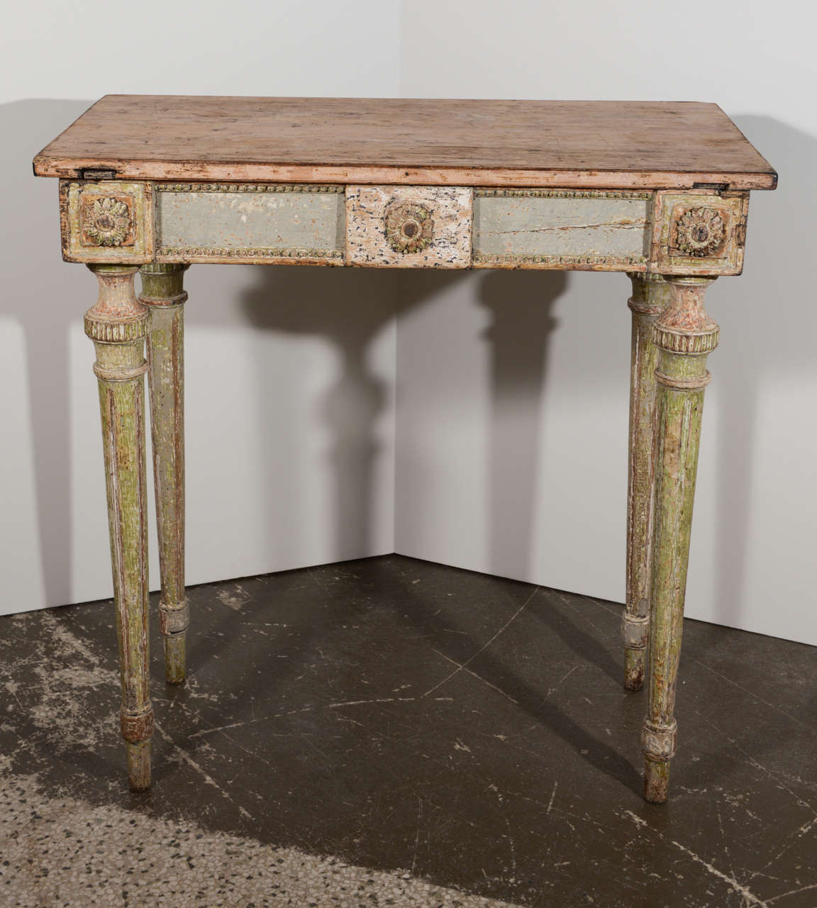 Period painted Gustavian console with Empire decoration and fluted legs.
