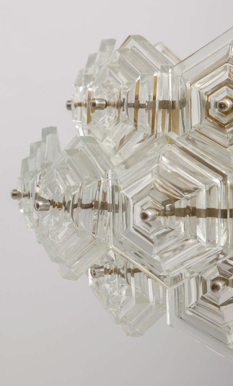 Modernist vintage chandelier very unusual design featuring prismatic glass elements with a Cascade hexagonal design molded. 

With the 1960s came the accentuated use of glass elements and vintage Italian lights manufacturing companies like Venini