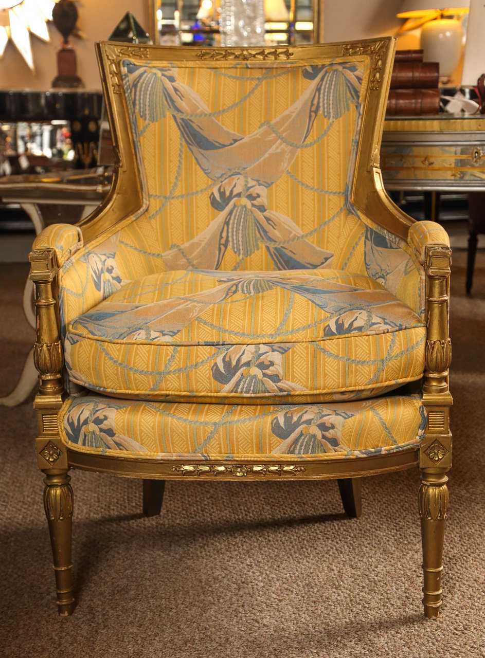 Pair of Maison Jansen Bergeres Louis XVI in Style. Fine Louis XVI style legs with carved designs leading to a carved lower apron the arms flanked by column supports with upholstered arm rests. The square back wood frame tops with leaf and vine