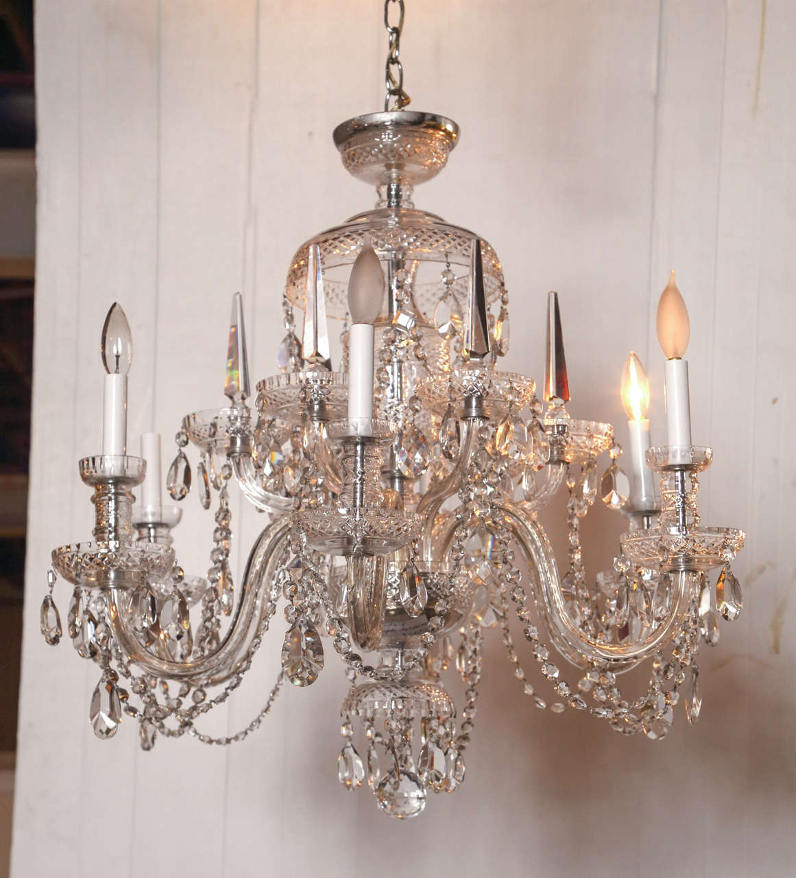 This fine  Chandelier having twelve arms with large cups is indicative of the old world Georgian look. The top having a rare cut crystal canopy with a cut crystal dome leading to a group of twelve cut arms and several candle snuffer arms. The