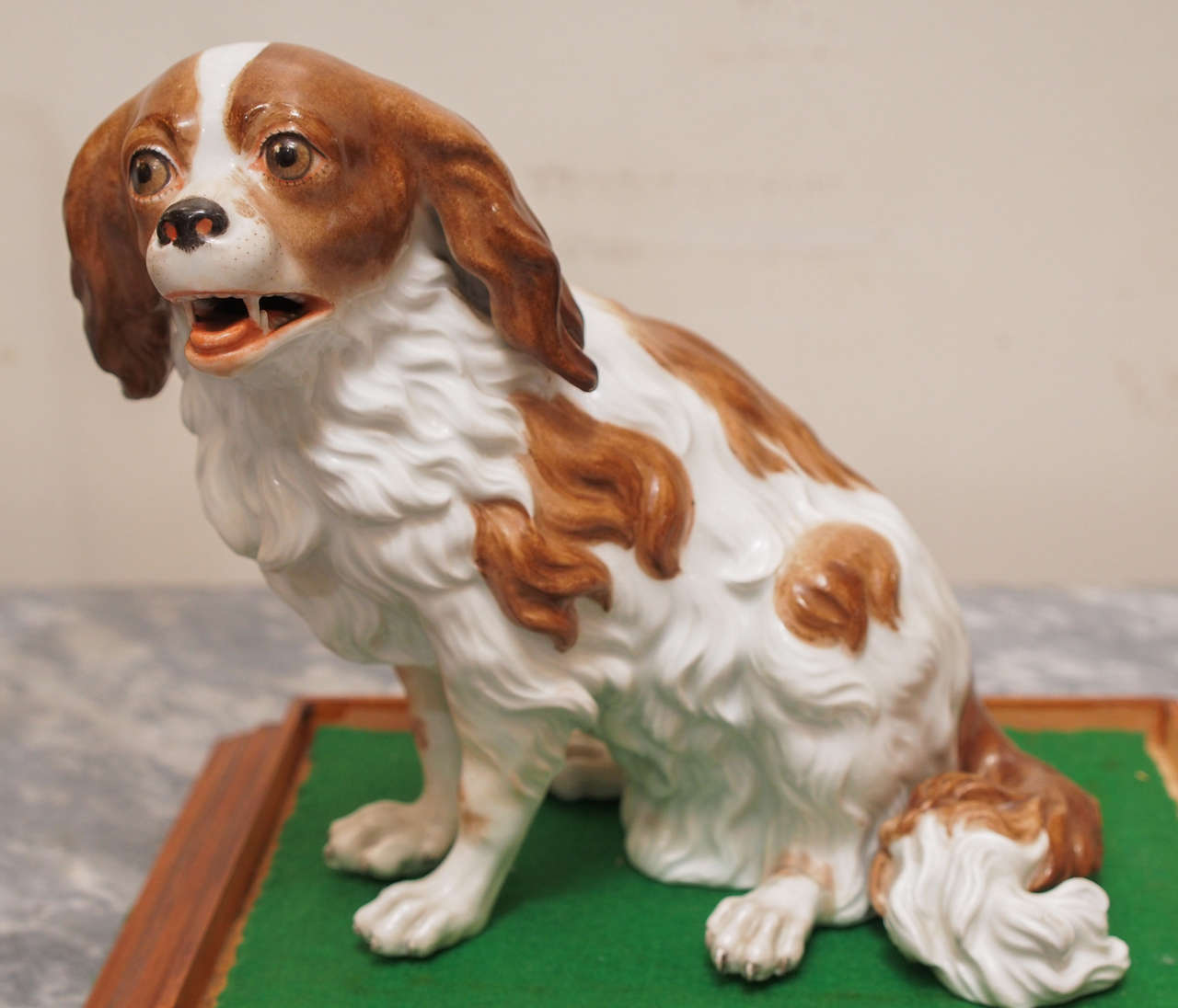 Vienna Porcelain figure of Cavalier King Charles Spaniel with beehive mark now ensconced in a custom glass and copper box with a wooden base.