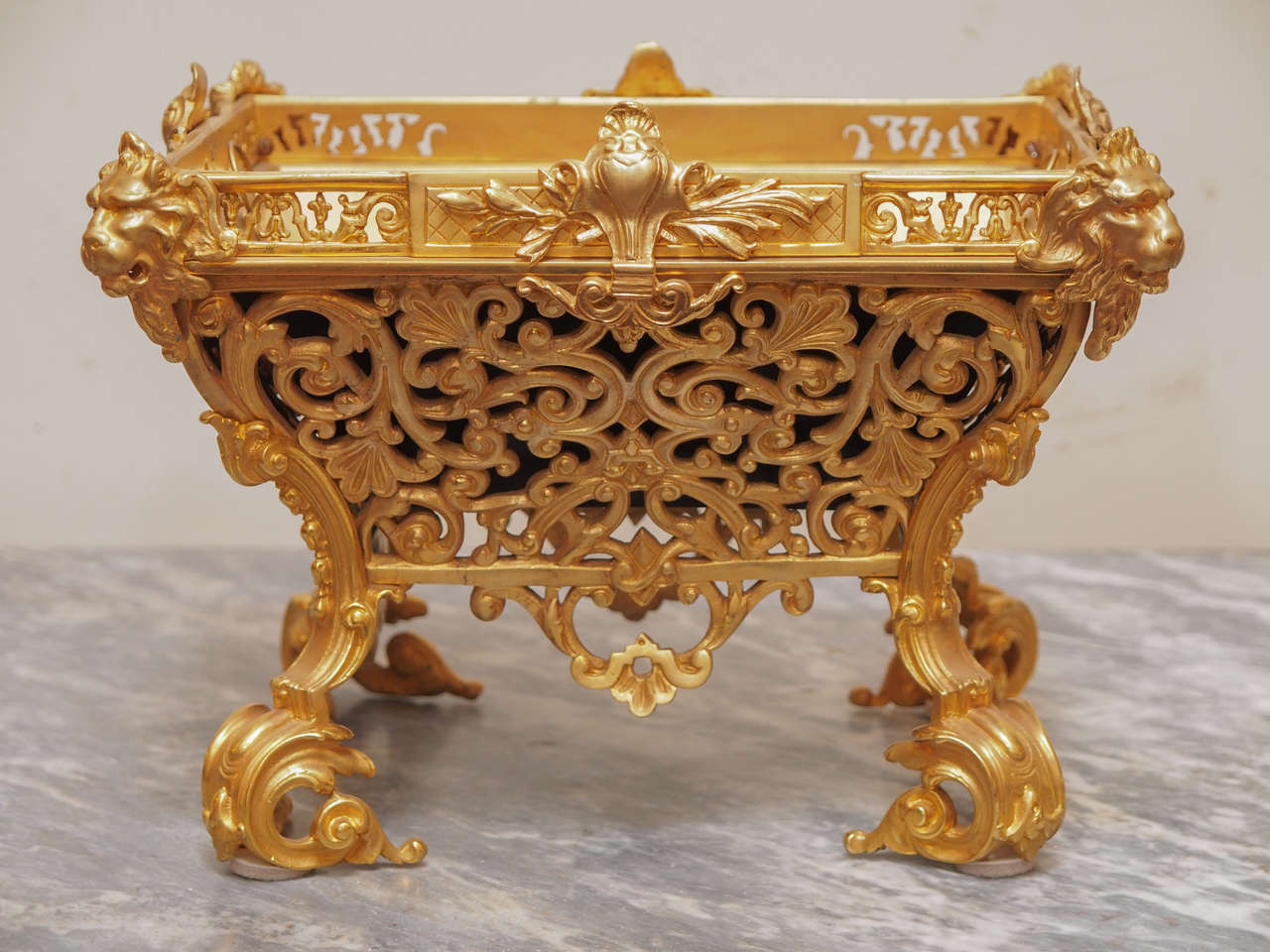 French Napoleon III Gilt Bronze Jardiniere with later custom liner. 
This jardiniere has lions heads on each corner with a cartouche on each side in the center and pierced foliate decoration all sitting on rolled feet.