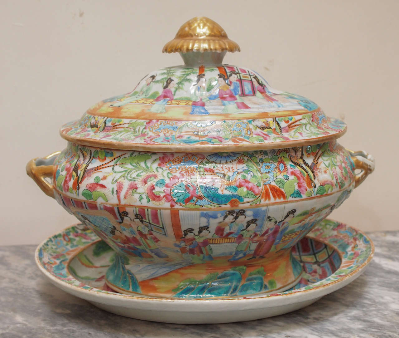 19th century Chinese famille rose lidded soup tureen and under platter. The tureen has double handles of foliate form with an artichoke finial.