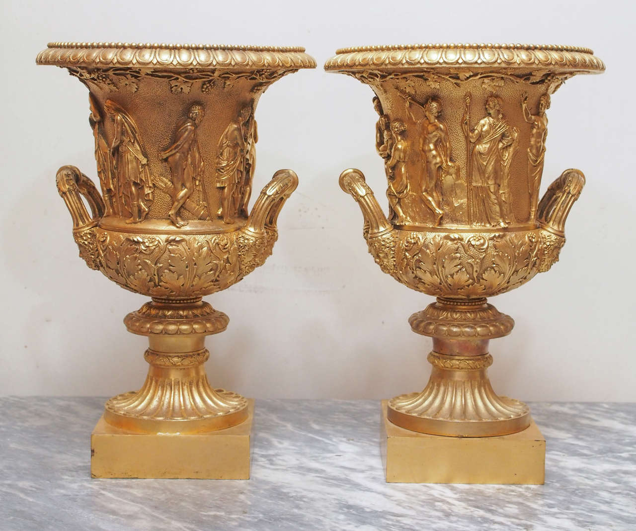 Pair of 19th century  grand tour gilt bronze Borghese form urns.