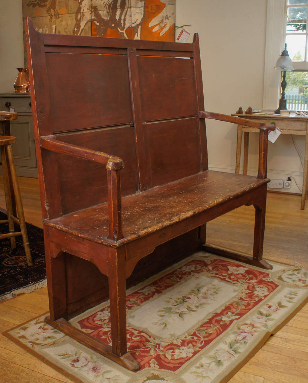 Exceptional is a good way to begin to describe this Welsh sledge foot George III settle. Its design is simple yet very unusual. The red paint is worn and authentic. A home in a mudroom, table side or den would be perfect for this early seat.