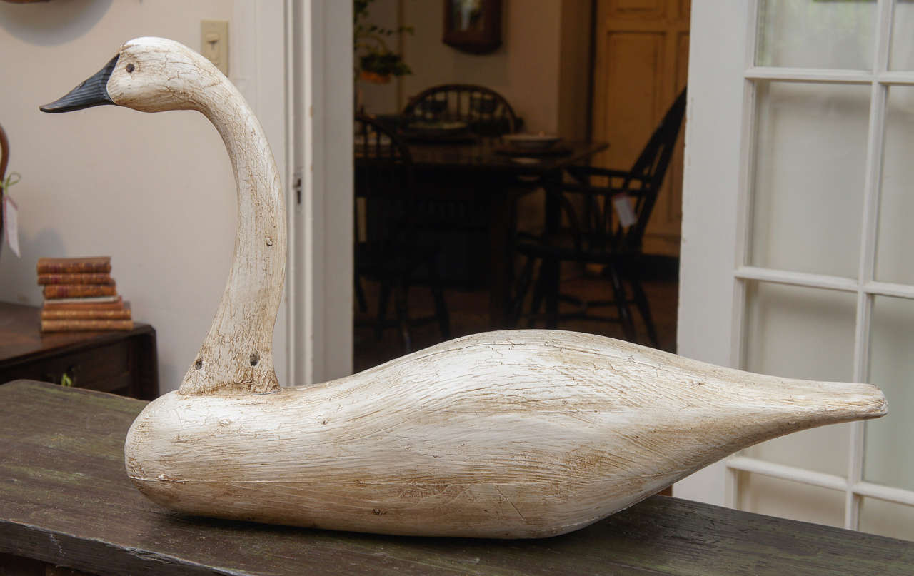 This is handmade by a nationally famous decoy maker in the southeast. His work is displayed in the American Folk Art Museum in NYC. He does pieces for Painted Porch, as well. This is a reasonably large piece that sits flat and is waxed to give it a