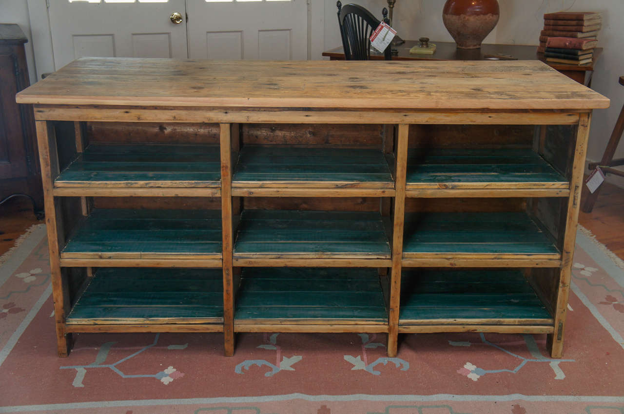 This food store counter is finished on all sides. The owner’s side has nine large green painted cubbies to store anything you would want in your kitchen. The height is perfect at 36