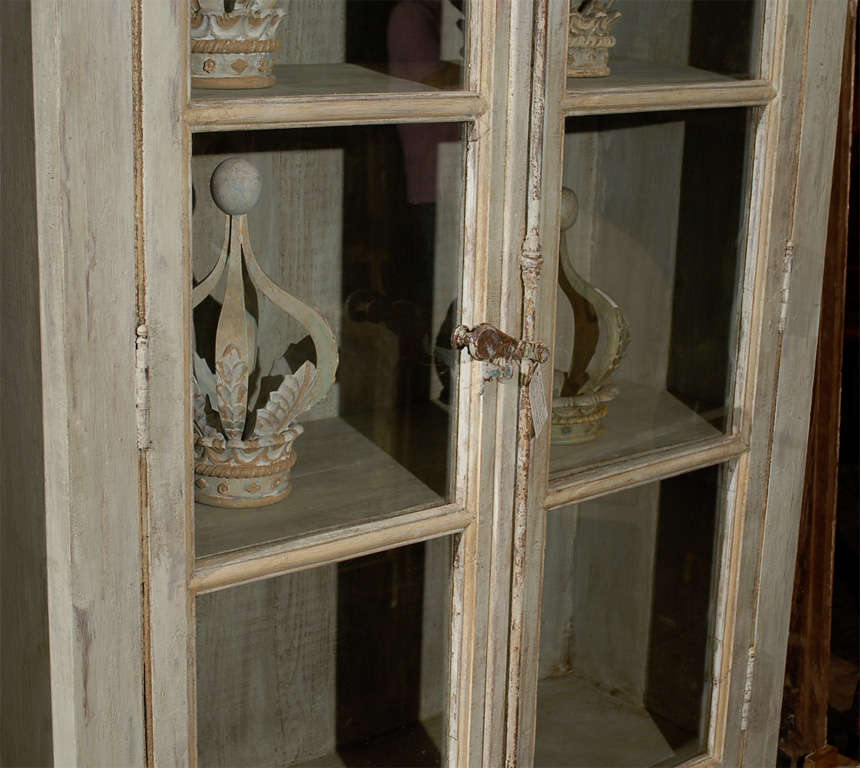 A Painted Wooden Bookcase with Glass Doors 1