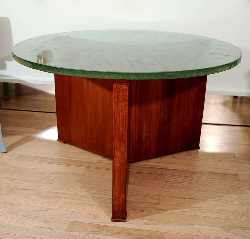 Rare and large tri-legged base table by Jacques Adnet, what set it apart is the thickness and color of it's St Gobain poured glass top (aka Nile glass) the base is Oak with walnut sabots. A rare find.