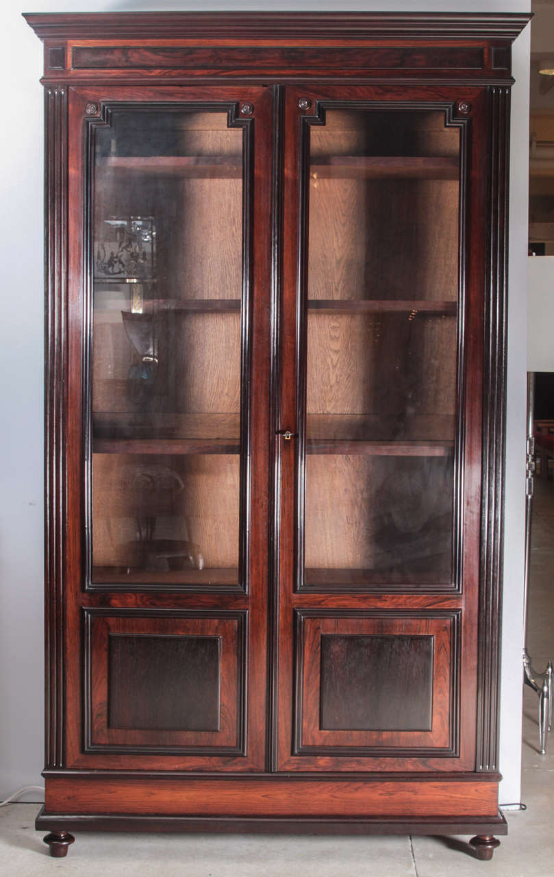 Handsome 19th  Century bookcase, rosewood and contrasting darker woods. The glass is original.
