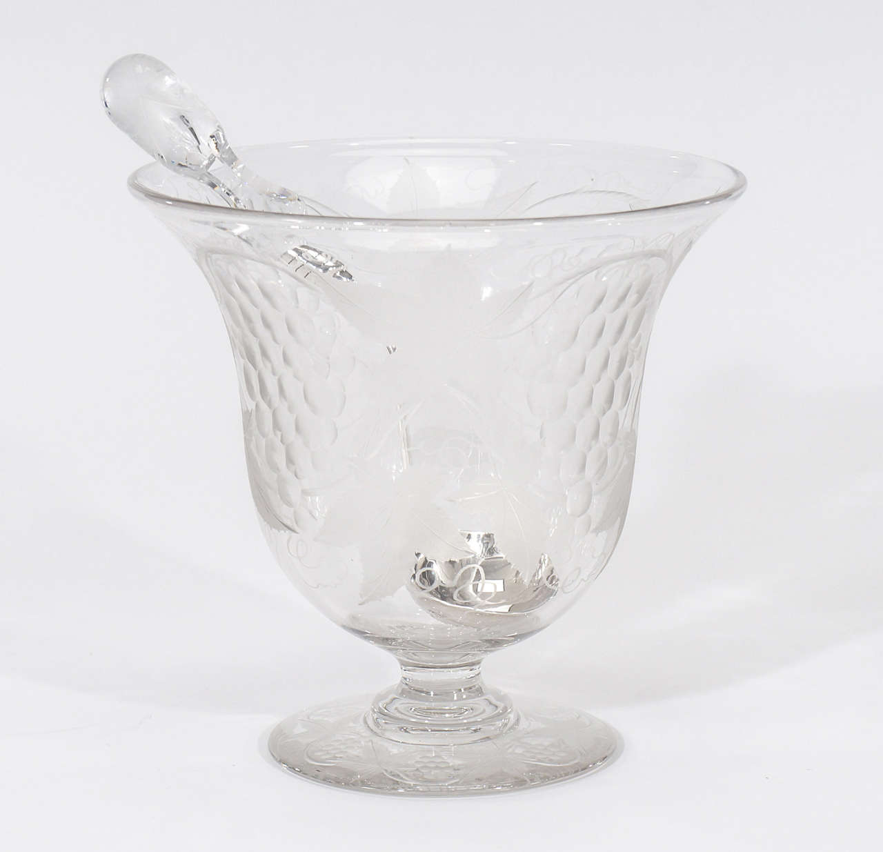 This example of a Pairpoint footed punchbowl sets te=he bar high! It even has the elusive matching signed ladle with an engraved crystal handle. The hand blown crystal bowl is engraved in the "Vintage" pattern, encircled with grapes and