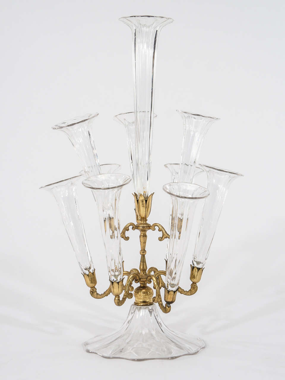 This unusual and elegant epergne is English attributed to Webb or Stevens & Williams and is a classic beauty. Not overly embellished, it features a single tall hand blown optic ribbed trumpet vase surrounded by 8 matching hand blown smaller ones.