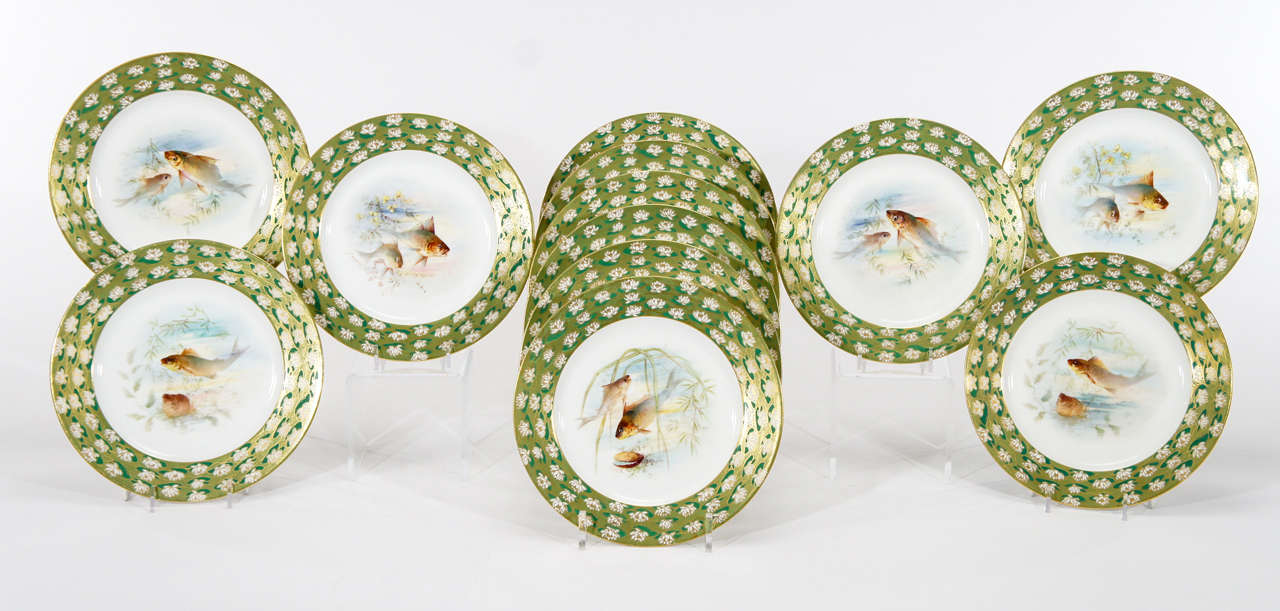 This set of 12 charming fish plates with printed fish and hand colored polychrome enamel decoration was retailed by Ovington Brothers, New York ca. 1910. These were de-accessioned from a museum (Jones Museum?) and feature the most unusual and