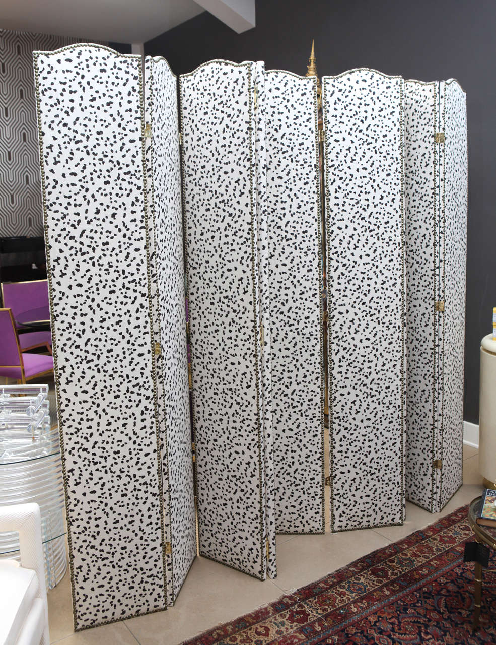 Custom upholstered 9-panel screen with brass nail head trim upholstered in Peter Fasano fabric.