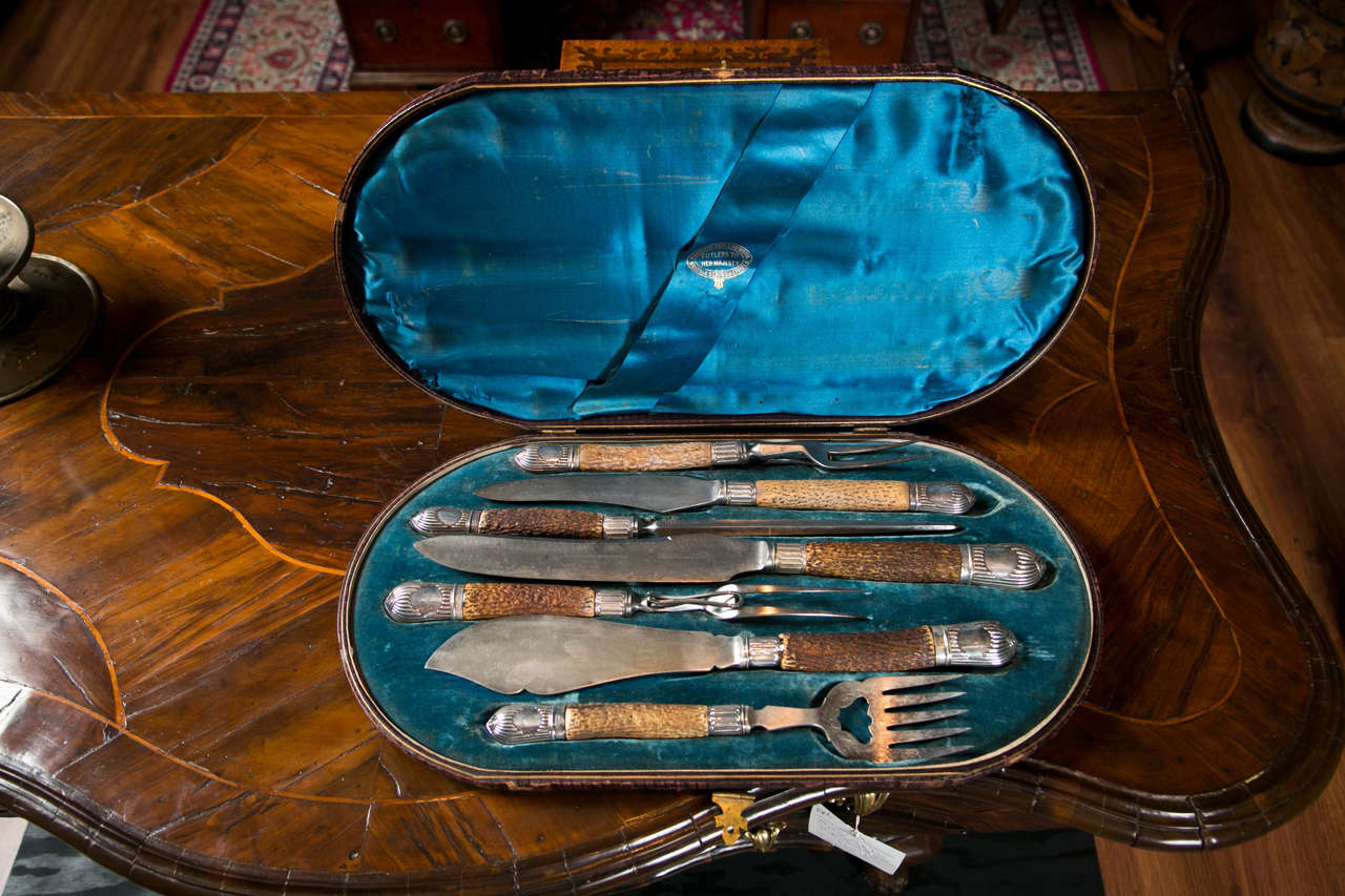 A fine quality English cutlery carving set by Harrison Bros. and Howson (Sheffield) cutlers to her Majesty Queen Victoria in Sheffield plate, the handles formed in horn and the tips are sterling silver marked with fleur-de-lis, probably French,