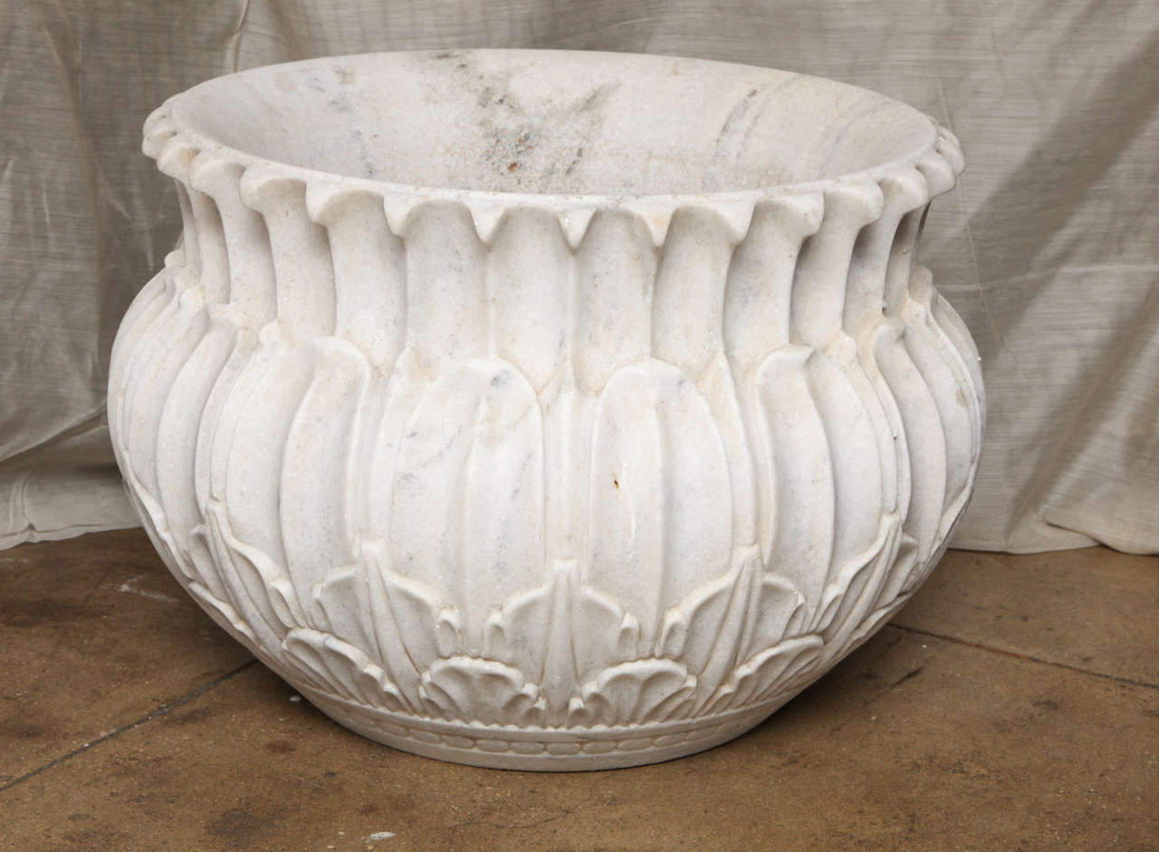 A large carved white marble planter from India. Classic symmetrical petal design.