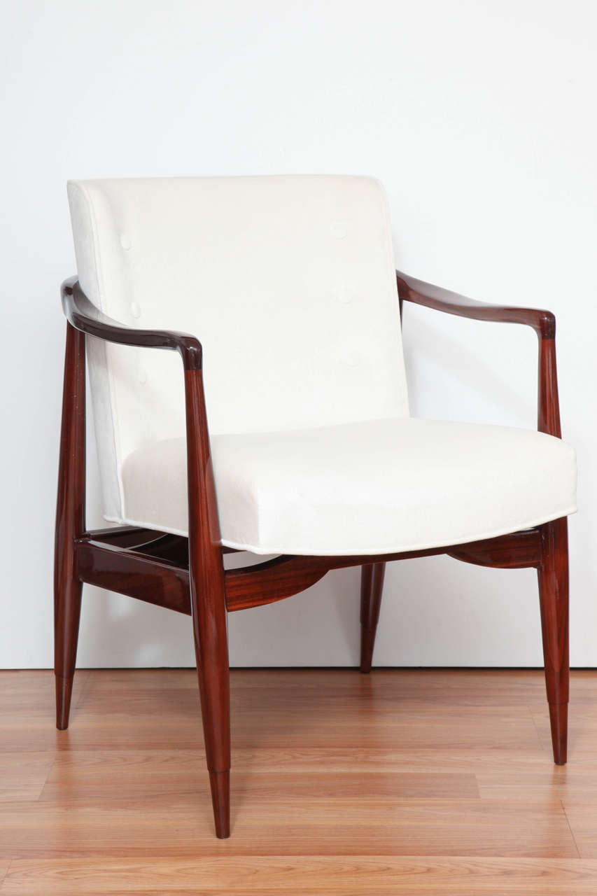 A pair of sculptural American Midcentury chairs with solid walnut frames and upholstered in a soft cotton fabric.