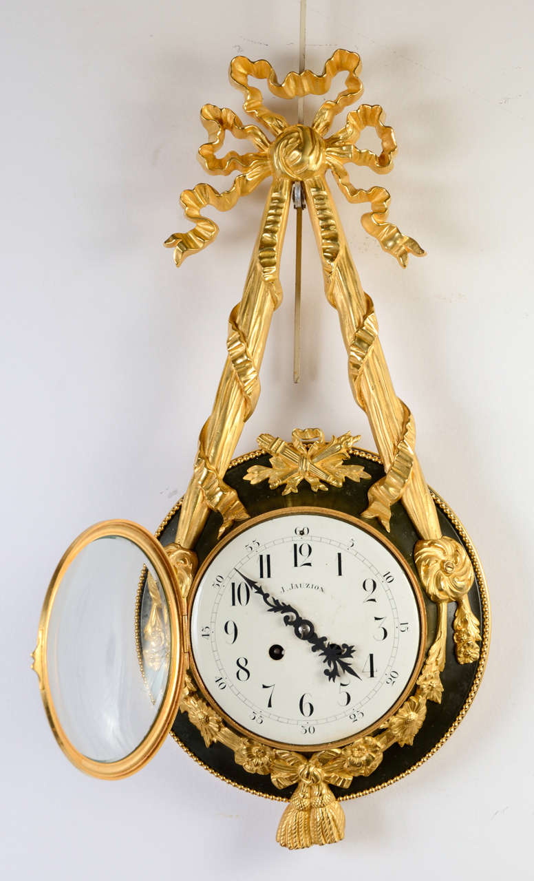 Louis XVI style gilded bronze and tole clock 
signed J. Jauzion