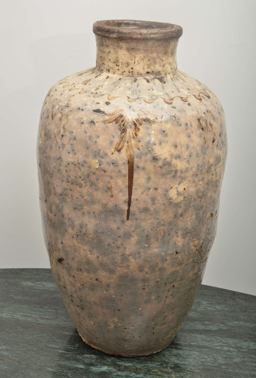 Beautiful stoneware vessel with transparent glaze over grey slipped body with hand-painted decoration. Decorated containers like this are associated with burial traditions in northern China and date to late Song Dynasty, circa 1550 AD.
