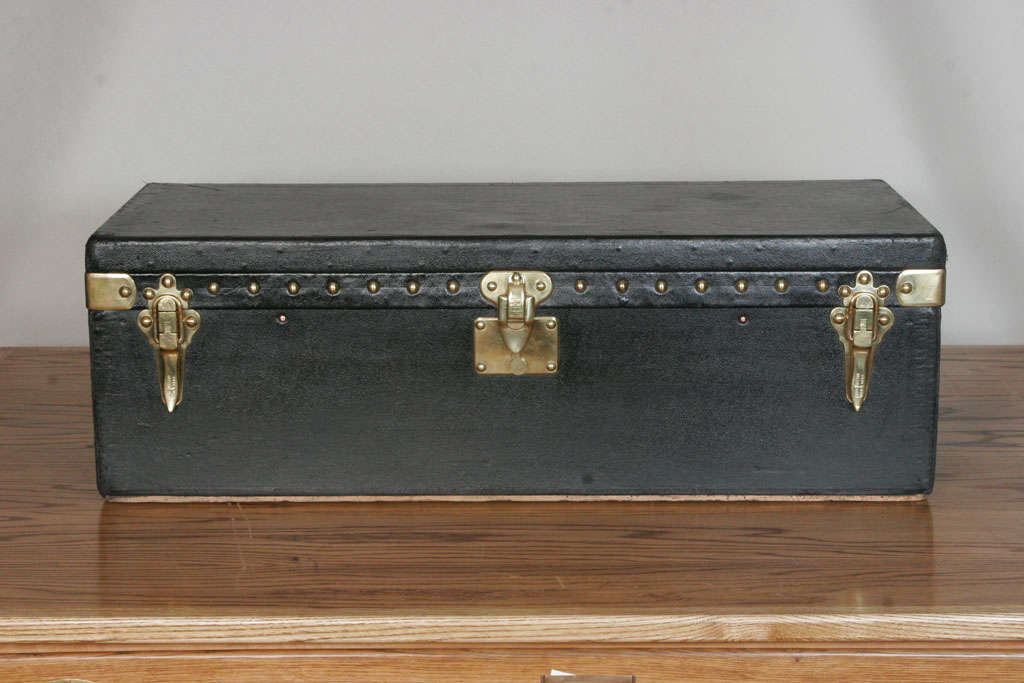 Black 'Vuittonite' motoring trunk with angled back originally designed to be mounted on the back of an open touring motor car and now would make for a characterful coffee table or storage space.<br />
Serial number and original Louis Vuitton label