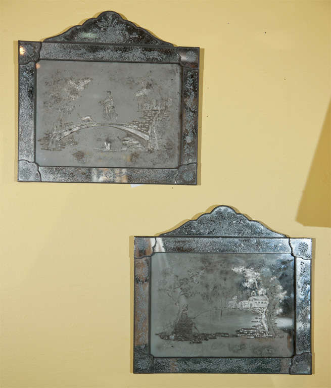 Pair of antique etched mirror plaques. Late 19th-early 20th century. Finely detailed and etched mirrors each depicting an oriental scene. Both having wooden backs.