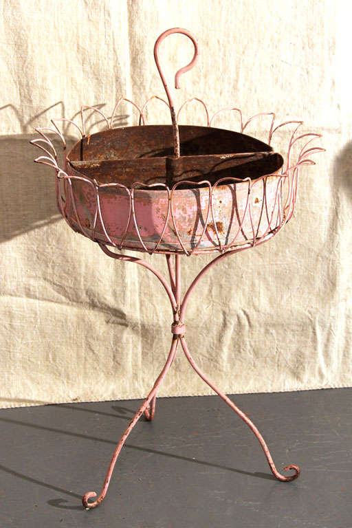 Pink wire stand with two semi circular trays. originally for plants or herbs, would be great as catch-all or for towel caddy.