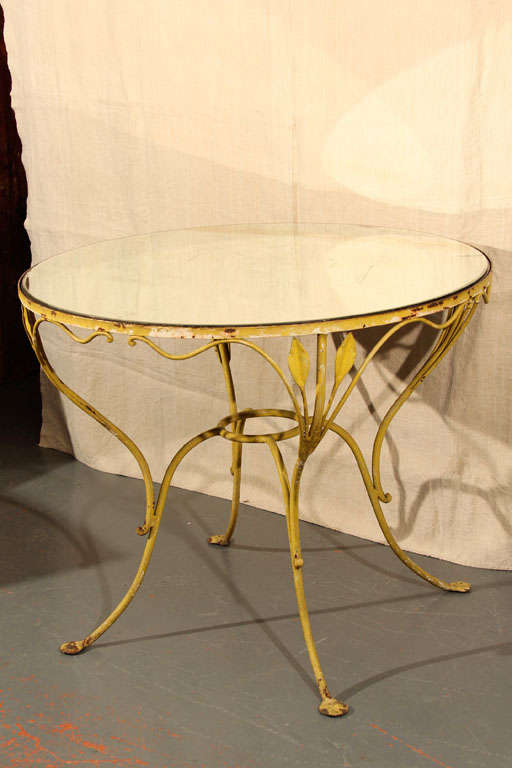 Yellow wrought iron garden table with original glass top. Beautiful indoors or out.