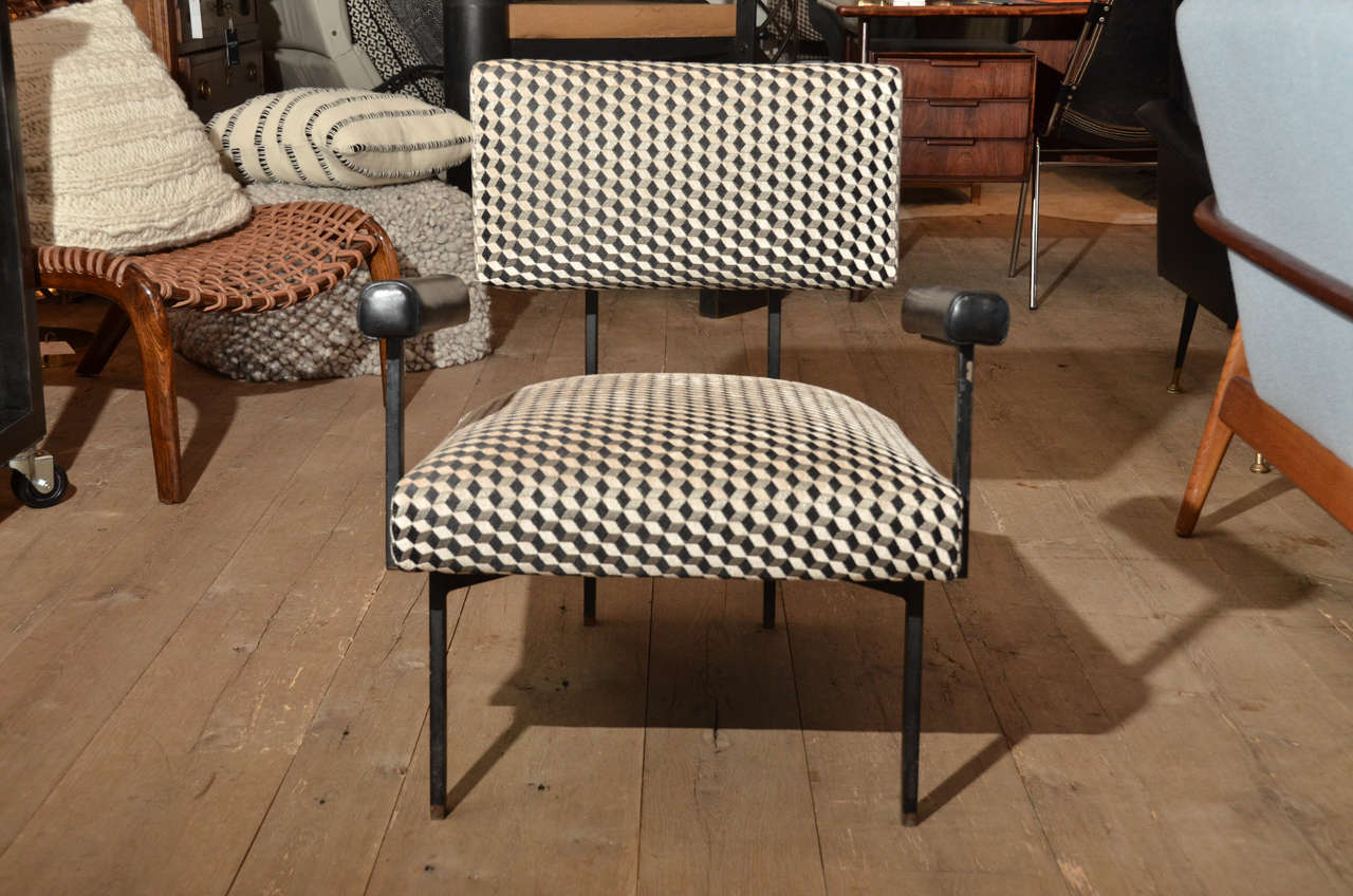 Stunning and very expensively crafted pair of Mid-Century Italian chairs with steel legs and leather armrest newly re-upholstered in graphic pattern fabric.
