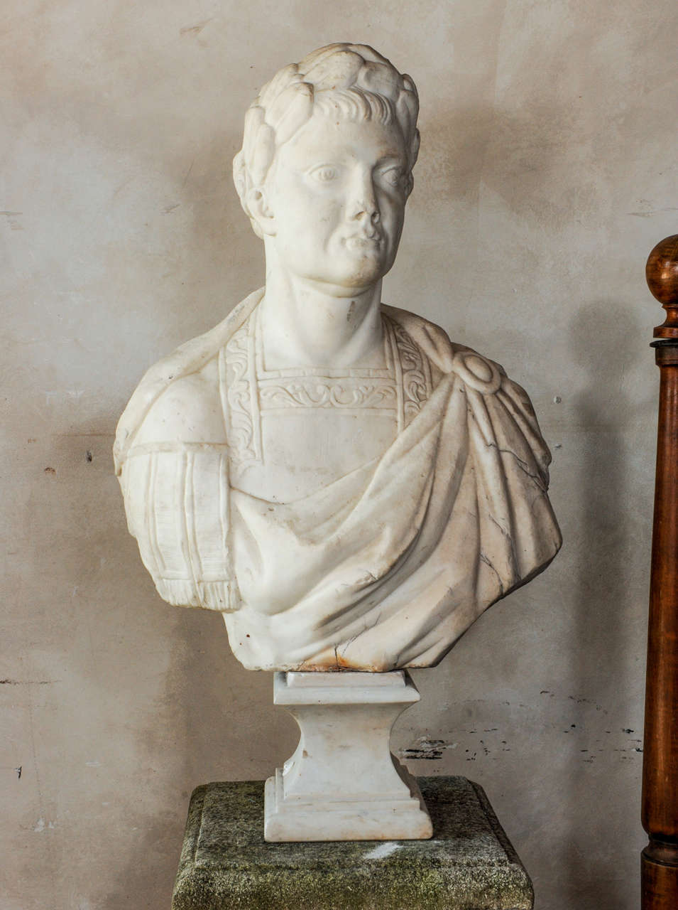 A 17th century marble bust of an emperor, depicted with his uniform and laurel. It's plinth is of later date. Signed Frugoni. 
Joseph  Frugoni was an Italian who worked in Marsella from 1897 to 1923.