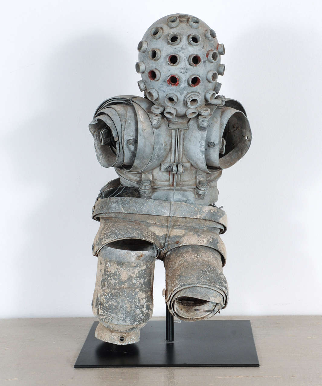Model of the first atmospheric diving suit (ADS). 
The Carmagnolle brothers patented their invention in 1882. Weighing over 830 pounds and joints not entirly waterproof. The suit never worked properly. 

The original is on display in the French