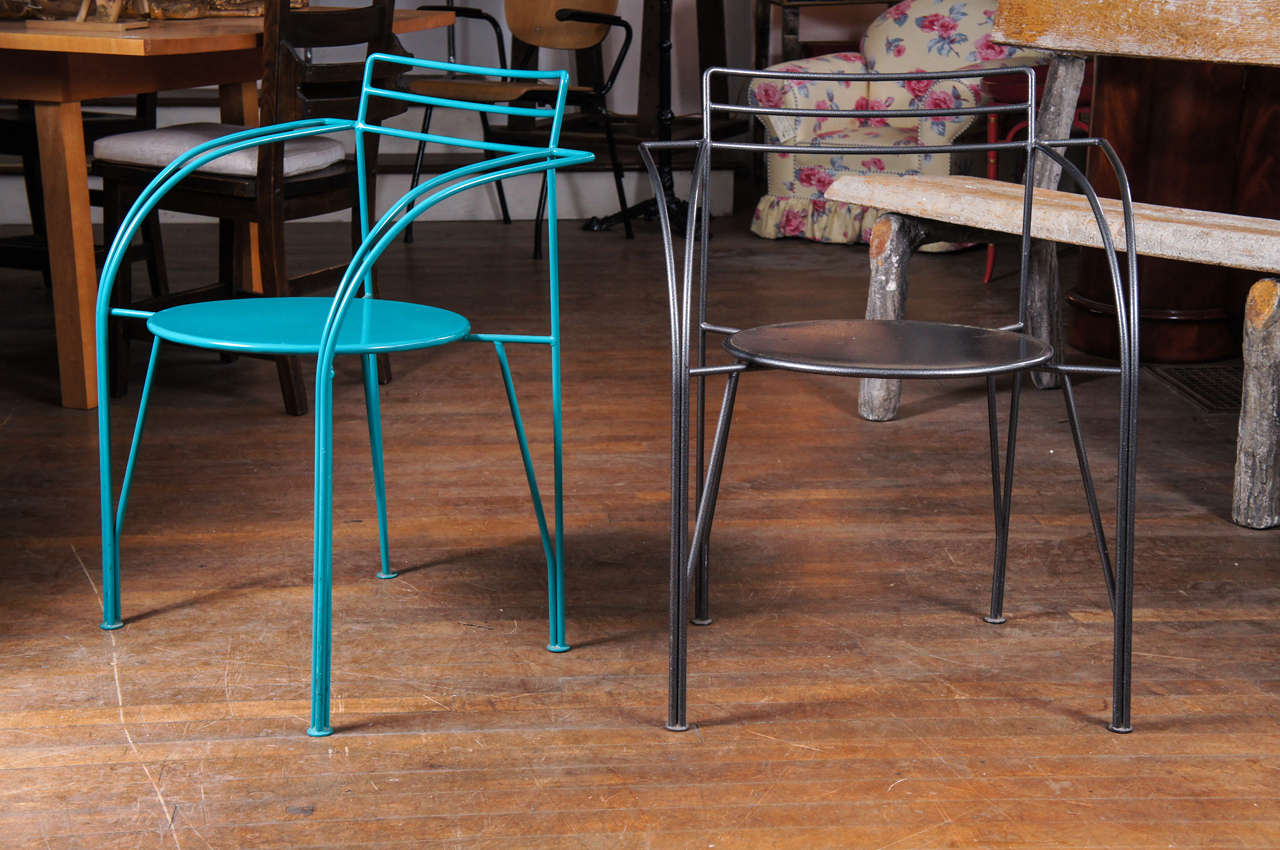 Pair of powder-coated metal armchairs, one metallic grey and
the other teal blue. Lune d'Argent chairs created by Pascal Mourgue.
This design was the winning entry in a 1985 competition for the Foundation Cartier Cafe.