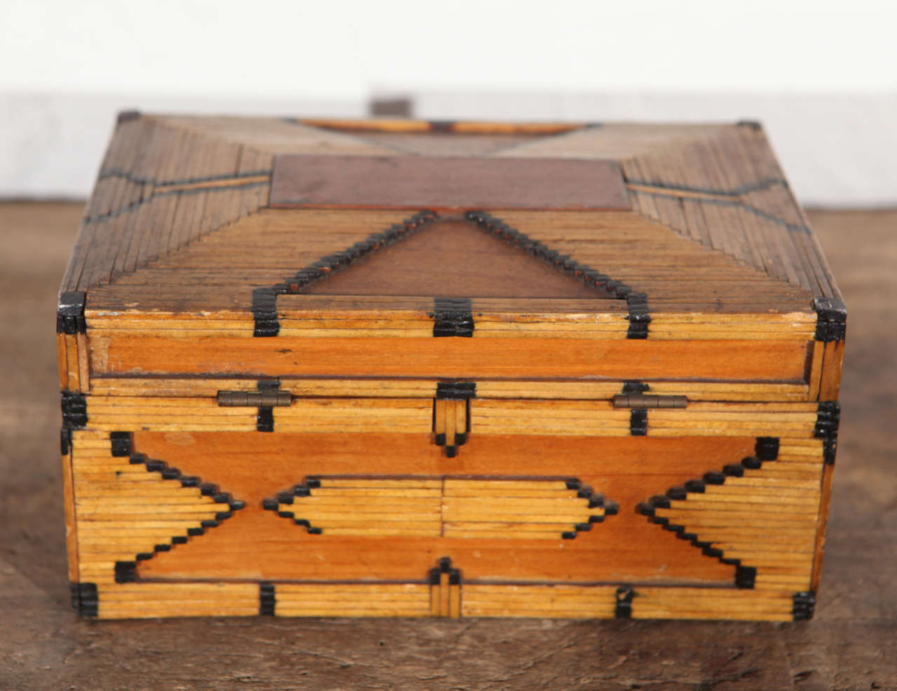 This unique decorative Folk Art box is a great piece of matchstick art. The burnt edged wooden matchsticks have been carefully inlaid with wooden pieces into geometric patterns that are especially handsome and striking with the contrast of the burnt