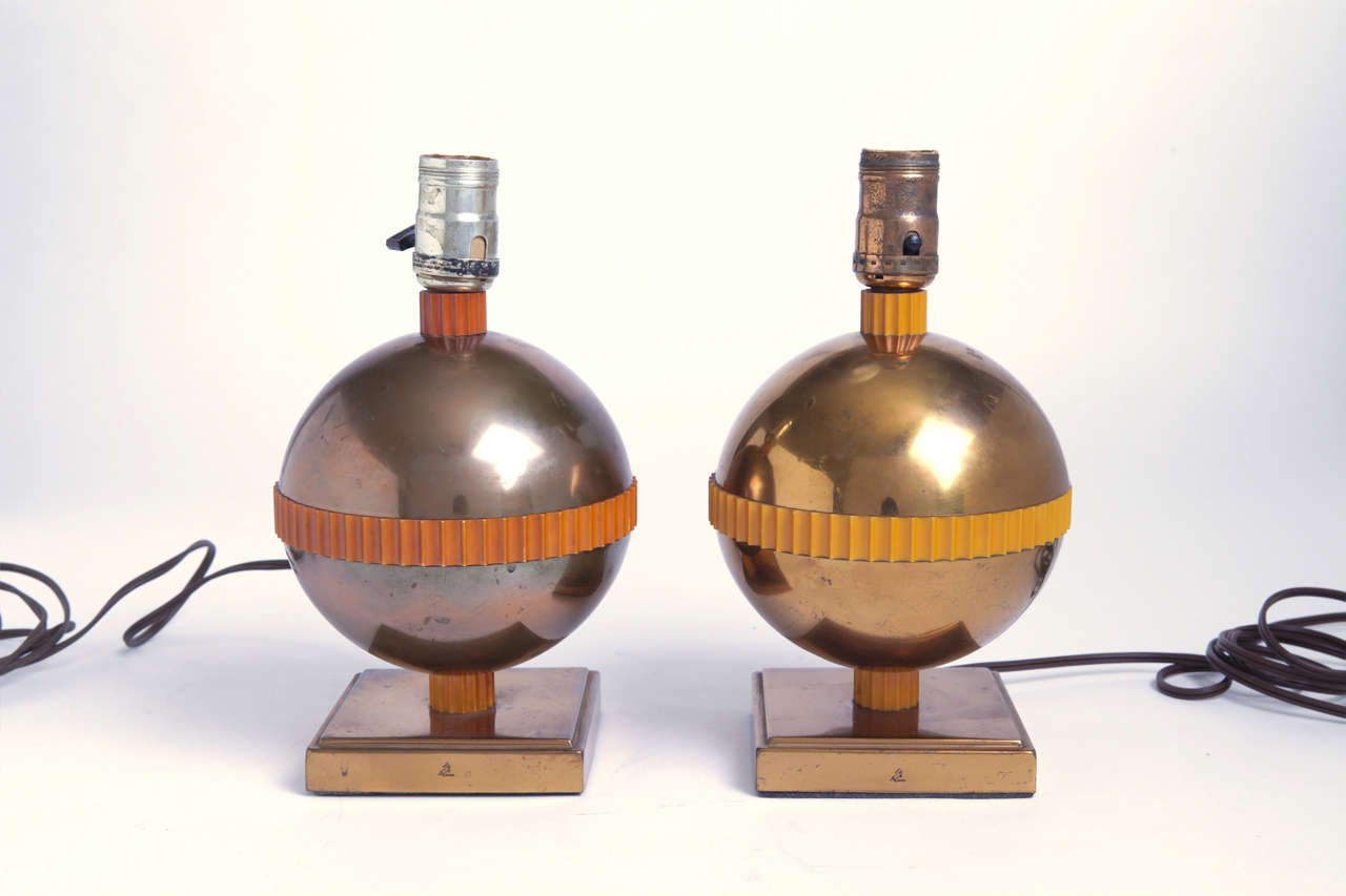 Two Nessen-design lamps for Chase in patinated copper and catalin.  Chase mark on both bases. Cat. # 01015.  Introduced in 1938.

Lamp on left has darker patination to copper and deeper darkening to catalin trim. Both in good condition.

Bases