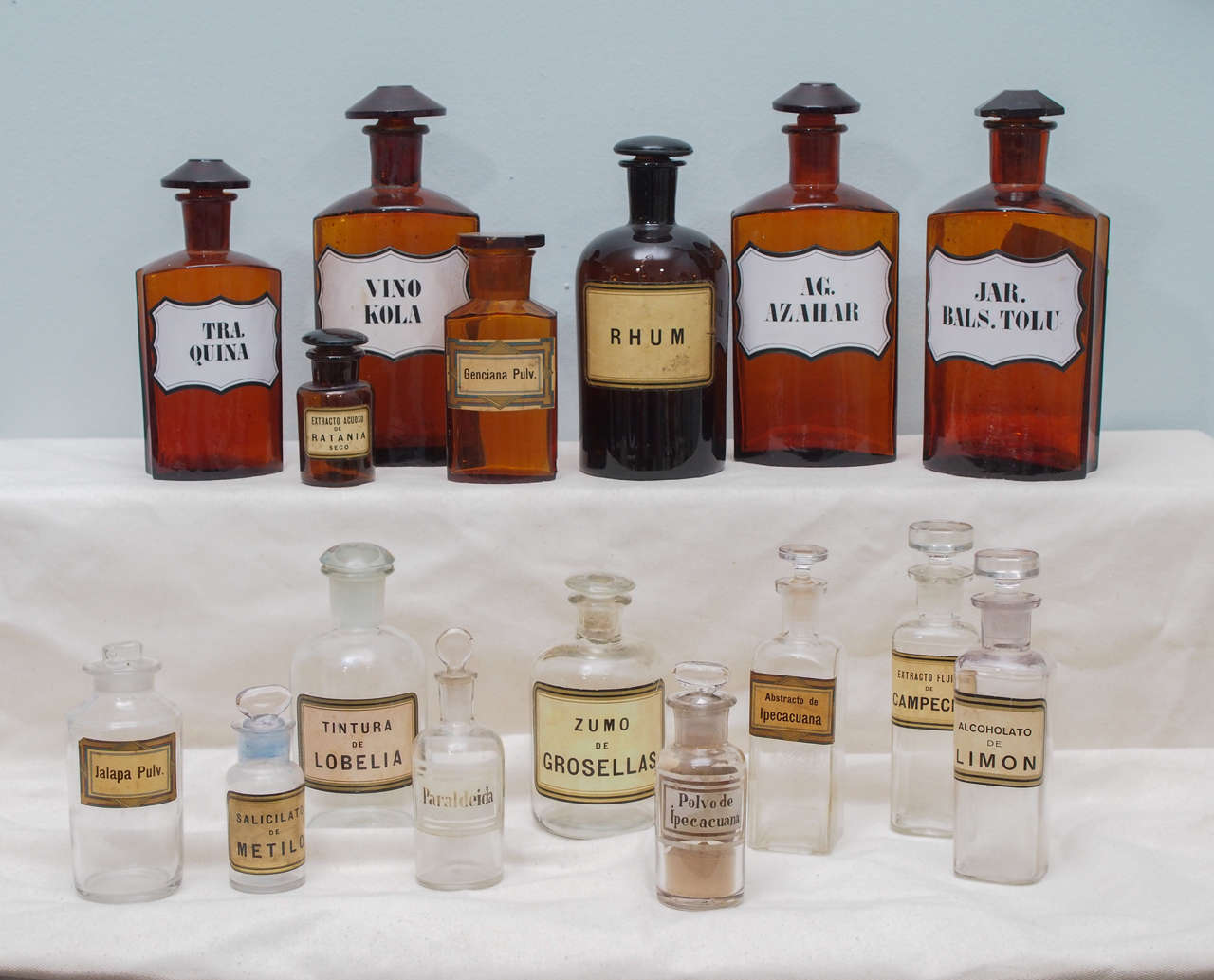 Collection of 16 apothecary jars, circa 1900-1920. The seven amber ones are German and the nine clear ones are from USA. The rectangular shaped amber jars are of crystal. The jars range is size from 10.5