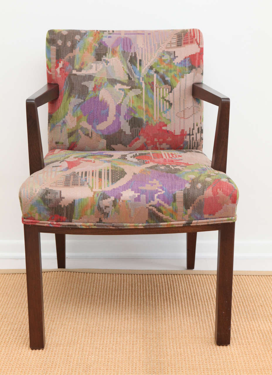 A set of four Dunbar lounge armchairs tufted with original Jack Lenor Larsen vibrant multicolored fabric with dark walnut arms and legs.