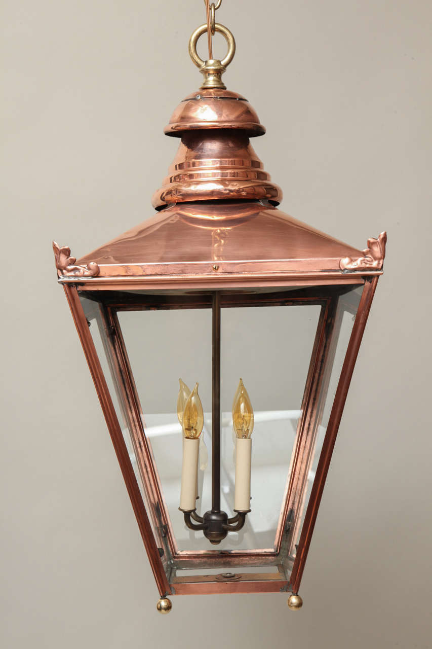 Good  English 19th Century gas lantern, now electrified and converted, having brass ring finial over four  trapezoid sides with palmette decorated corners, hinged door and four bulb fixture.