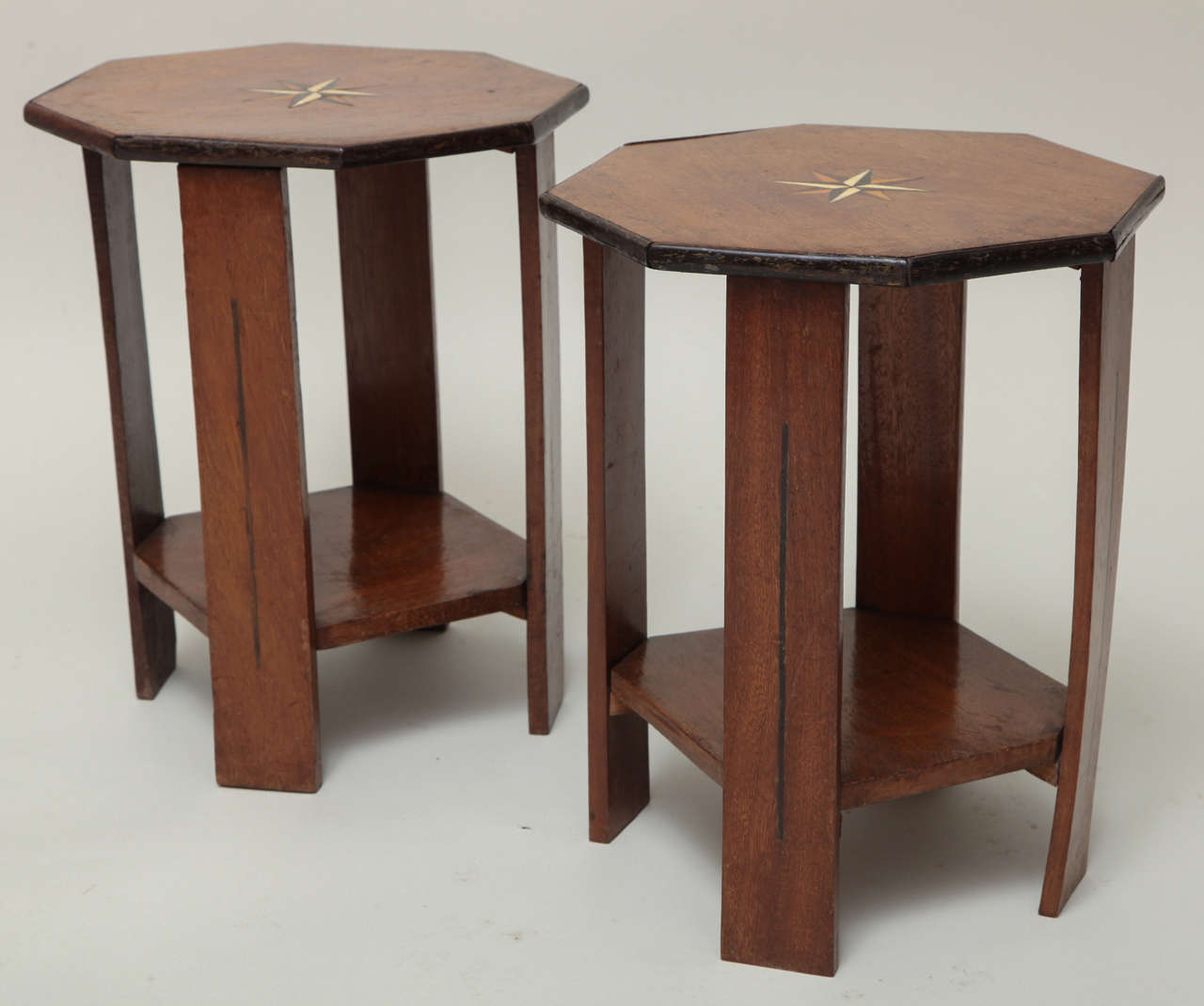 Pair of 1920s Indian octagonal side tables having ebony banding, bone, sandalwood and ebony compass star inlaid tops, the four legs with ebony stripe inlay, the legs joined by shaped shelf.