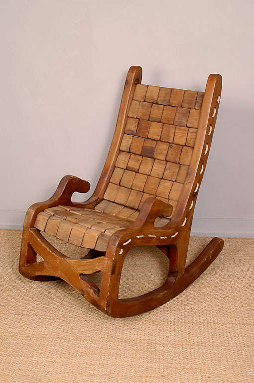 Interesting 1970's craftsman made rocking chair from California.  Seat and back are ergonomically designed and are made out of 78 hand cut blocks of wood that are held together with rope and attached to the frame of the chair.  Hand pegged and
