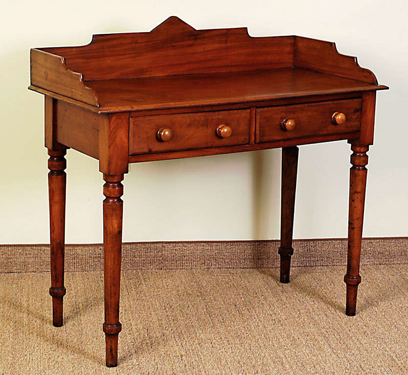 Nicely scaled piece. Originally used as a washstand but would make a great writing desk. Single Board Top. cut away back splash with 2 drawers wooden knobs.

View our complete collection @ www.hollisandknight.com