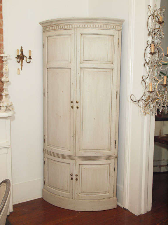 Oyster grey swedish style corner cabinet with dental crown molding and original brass hardware.