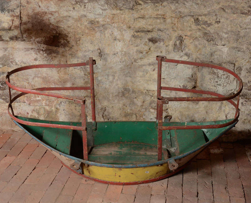 Boat-shaped swing. This object used once for fun rides at an old carnival, in time became a small sculpture by its shape, patina and colors, very decorative object with the most beautiful effect.
Still can be used as a swing in a beautiful yard!