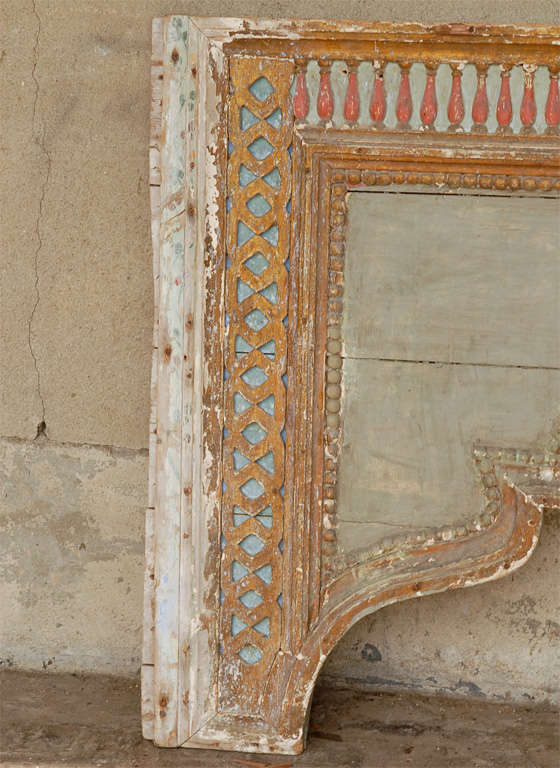 A European 19th century large size painted and giltwood wall decoration, richly carved with balusters. Delicately carved volutes join in the center of this wall ornament. They are decorated on the inside with beading. 
This European large size wall