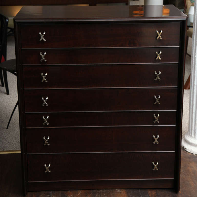 Seven-drawer chest of dark stained wood with brass X-pulls and raised detailing. Simple, elegant form with lots of storage.