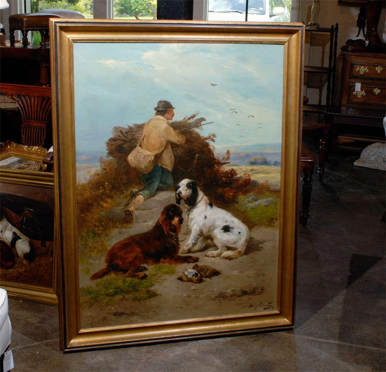 Very Large Belgian oil painting of a hunter with his dogs in a landscape in a gilt frame.